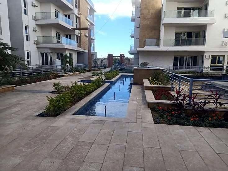 Water channel, planting and stone paving at Podium 8